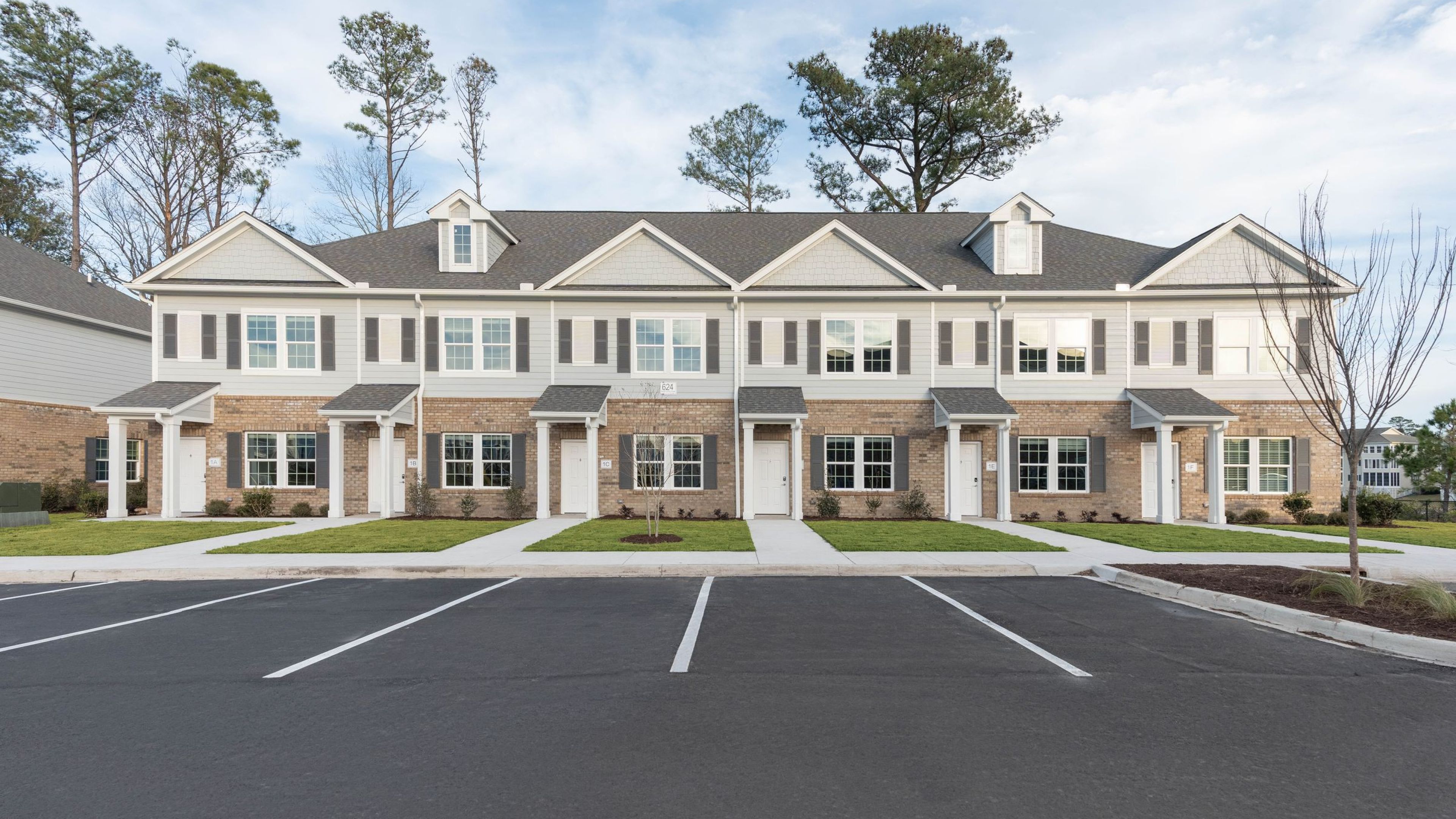 Hawthorne Waterway townhomes exterior with front door and large windows with parking in front