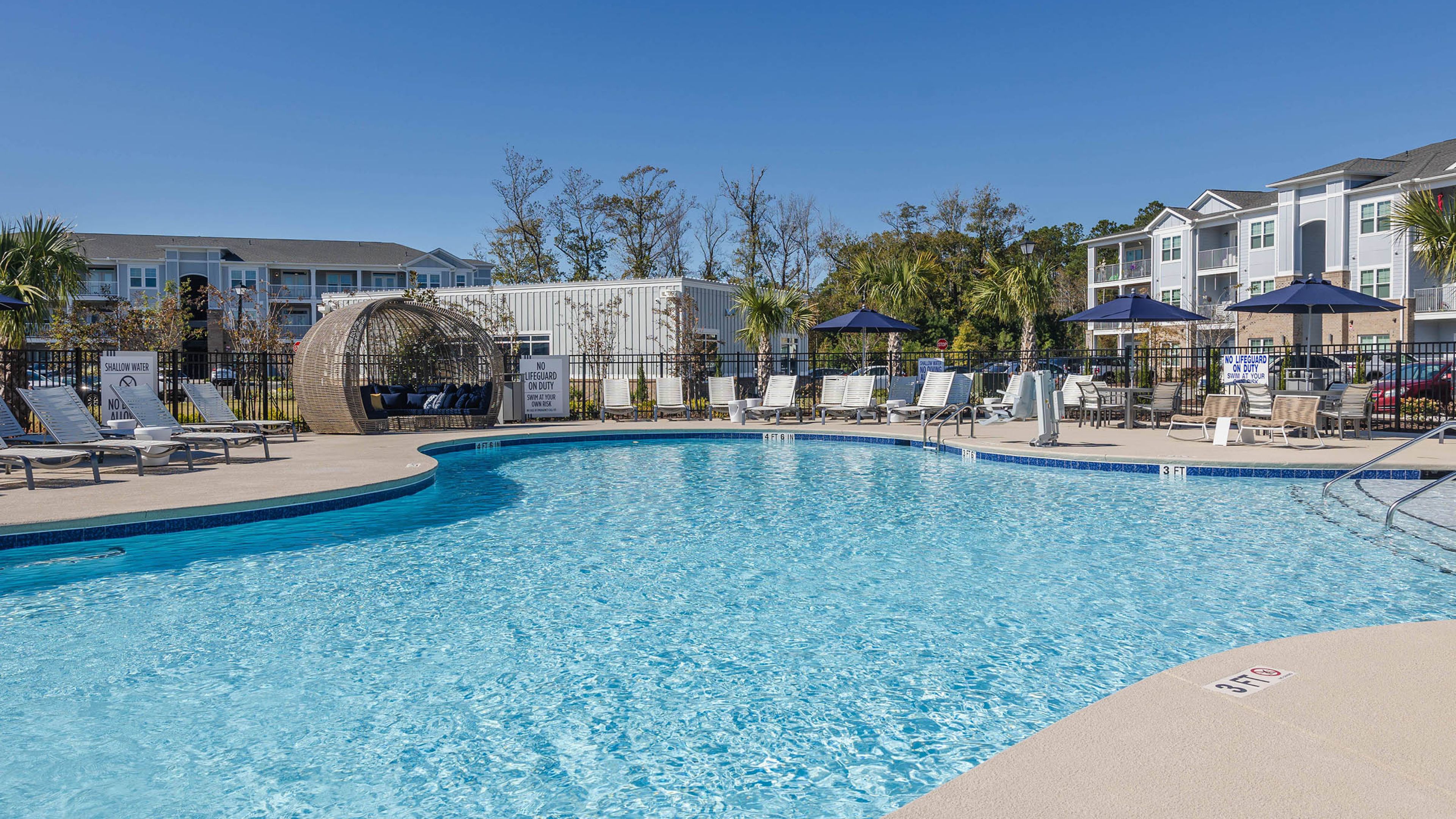 Hawthorne Waterway luxury outdoor pool with in-pool lounge chairs and surrounding seating