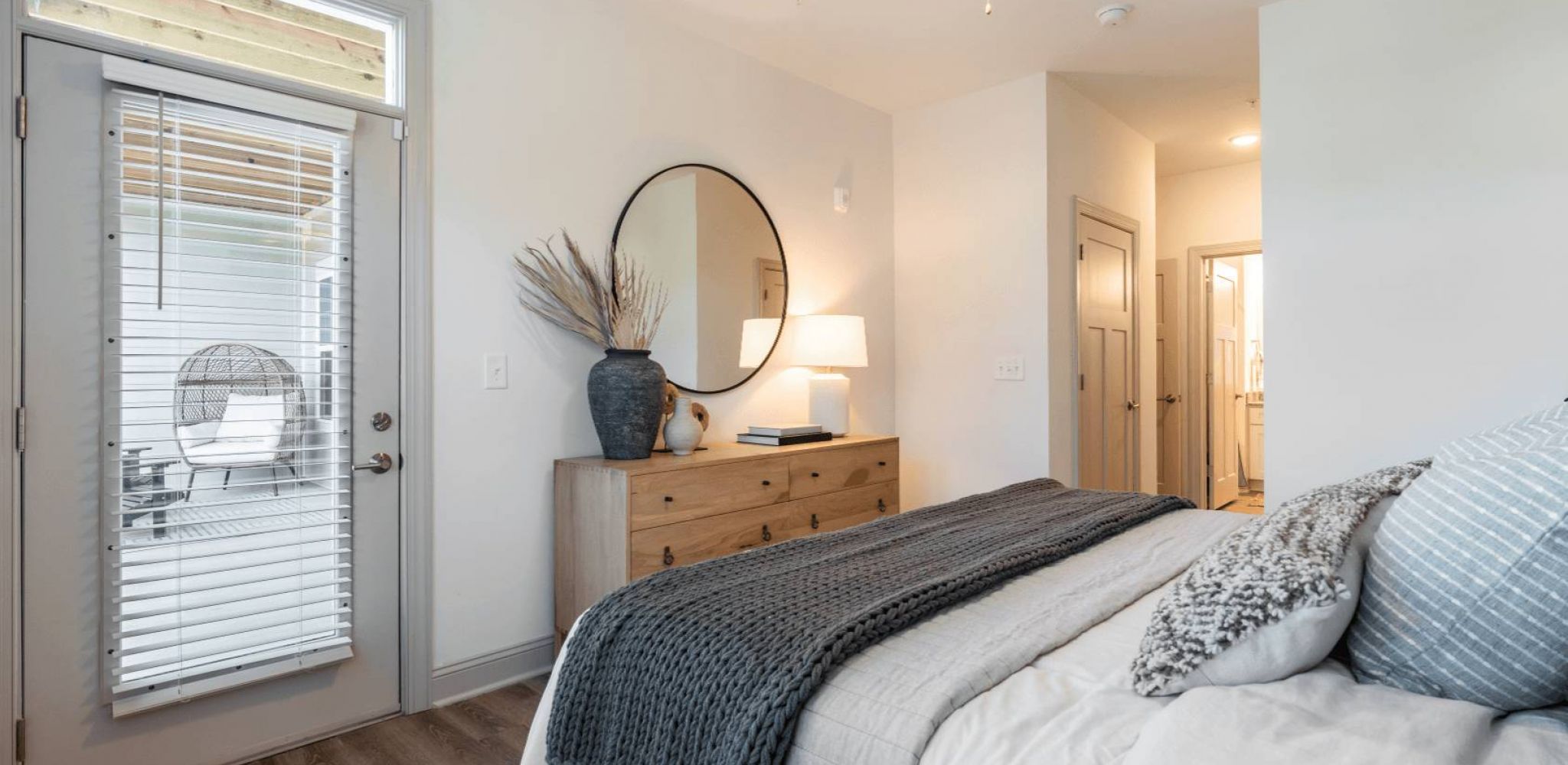 Hawthorne Waterway spacious apartment bedroom with hardwood floors and large windows