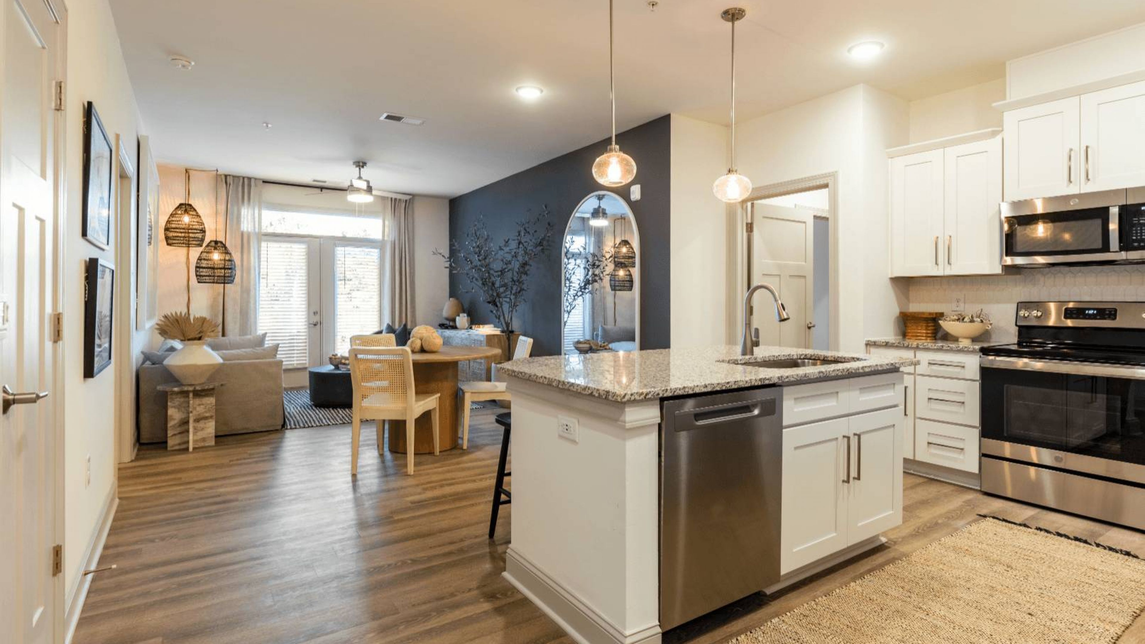 Hawthorne Waterway apartment kitchen and living space with kitchen island and large patio doors