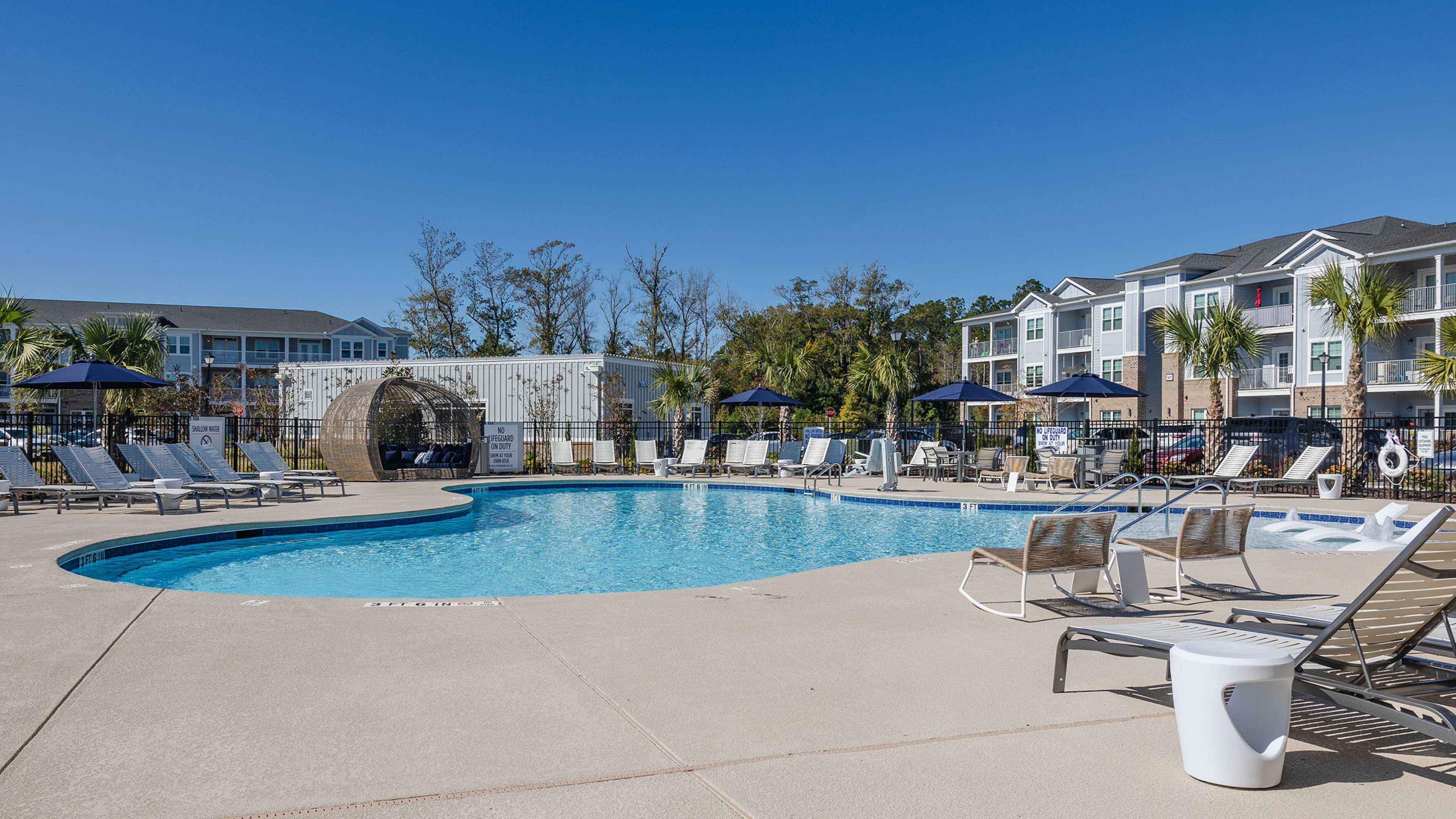 Hawthorne Waterwayluxury outdoor pool with in-pool lounge chairs and surrounding seating